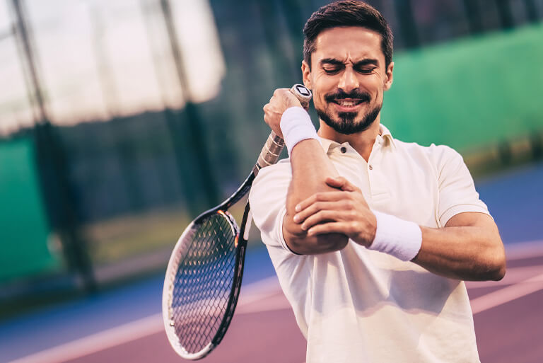 tennis player suffering with elbow pain