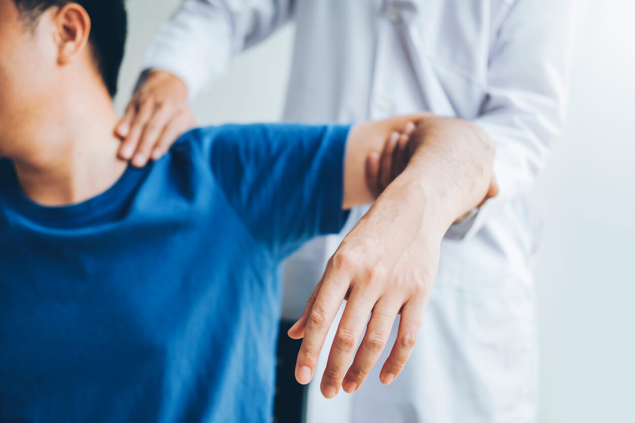 Doctor consulting with patient About Shoulder Injury