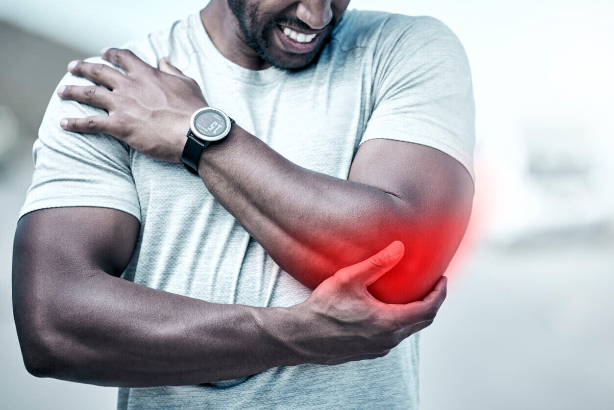 Man experiencing injury pain at elbow