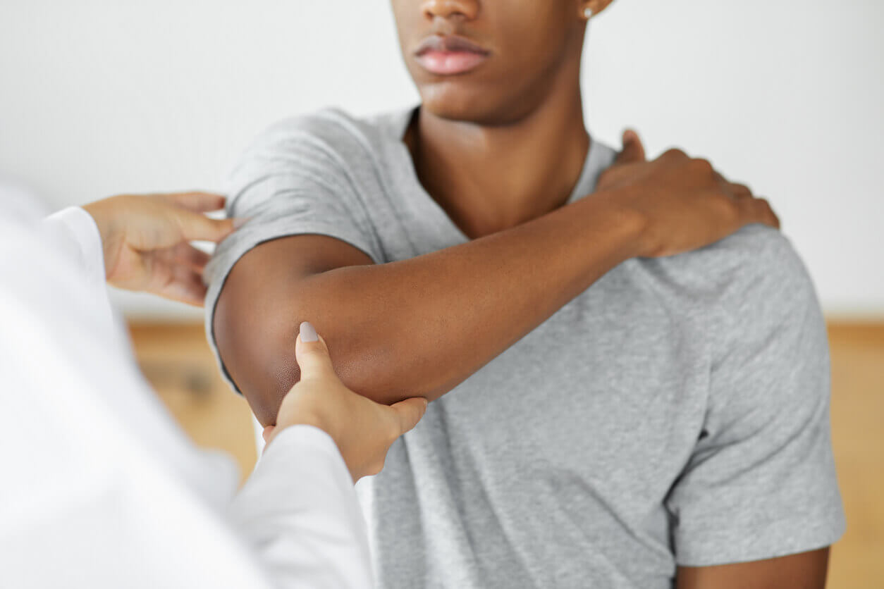 Doctor checking patient with elbow to determine the cause of illness